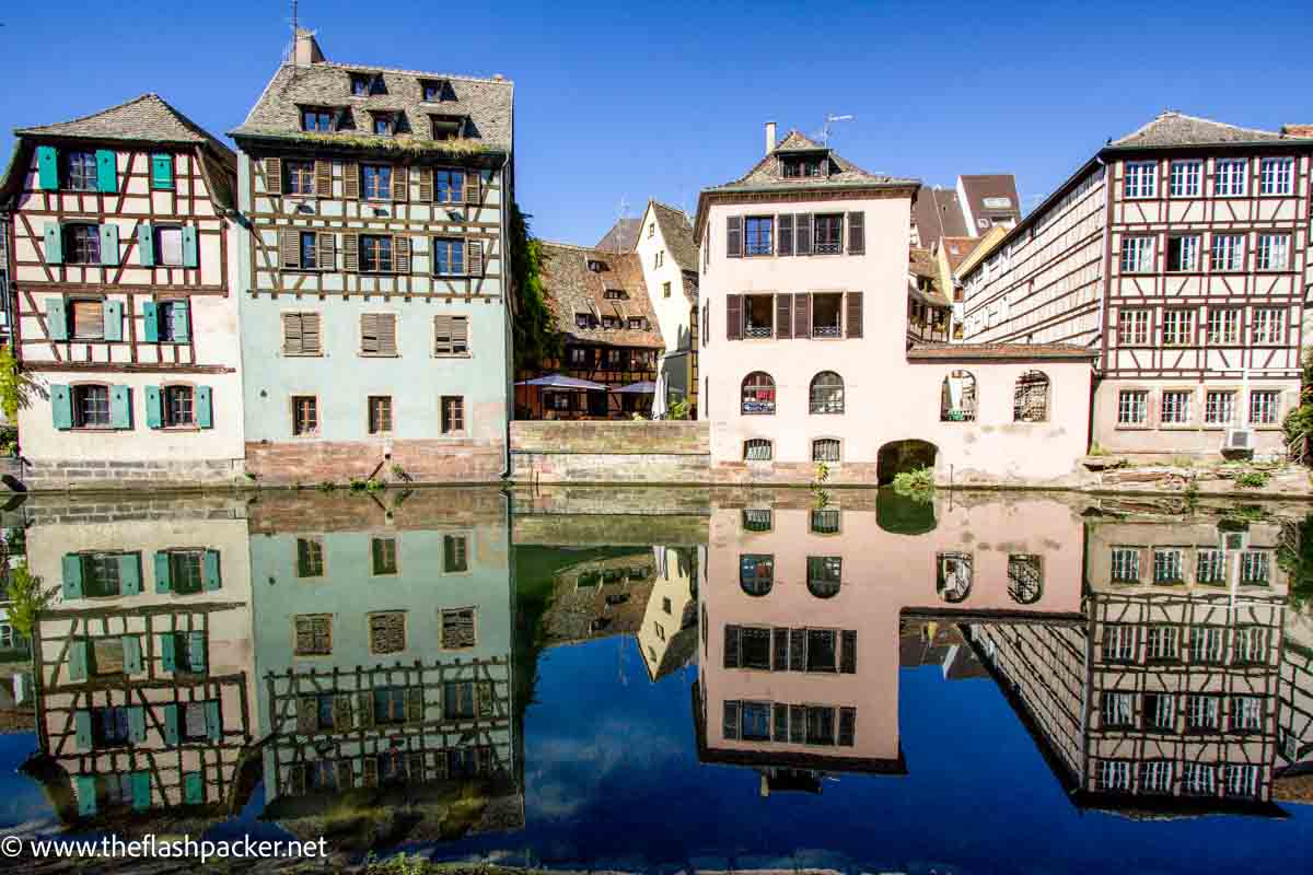 half timbered buildings reflected in canal seen in one day in strasbourg free walking tour