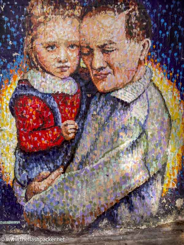 painting of a man holding a small child