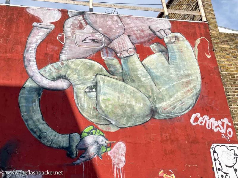 wall mural of a pink and green elephant