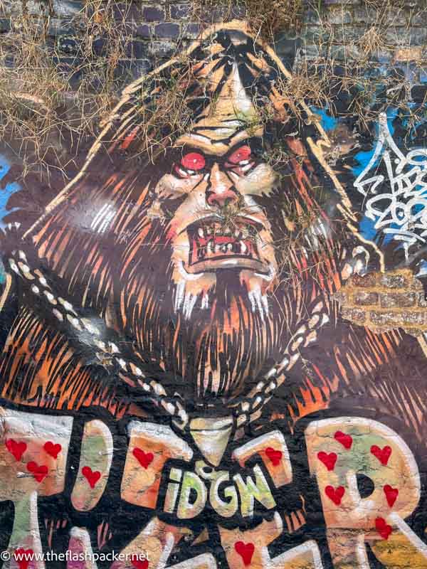 wall mural of a beast with long har and beard and red eyes