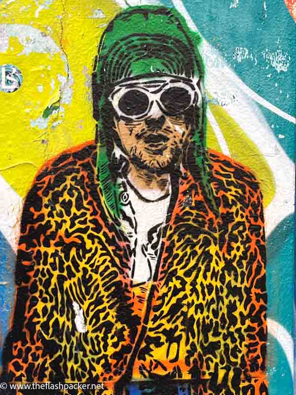 wall mural of kurt cobain wearing a leopardskin coat and sunglasses