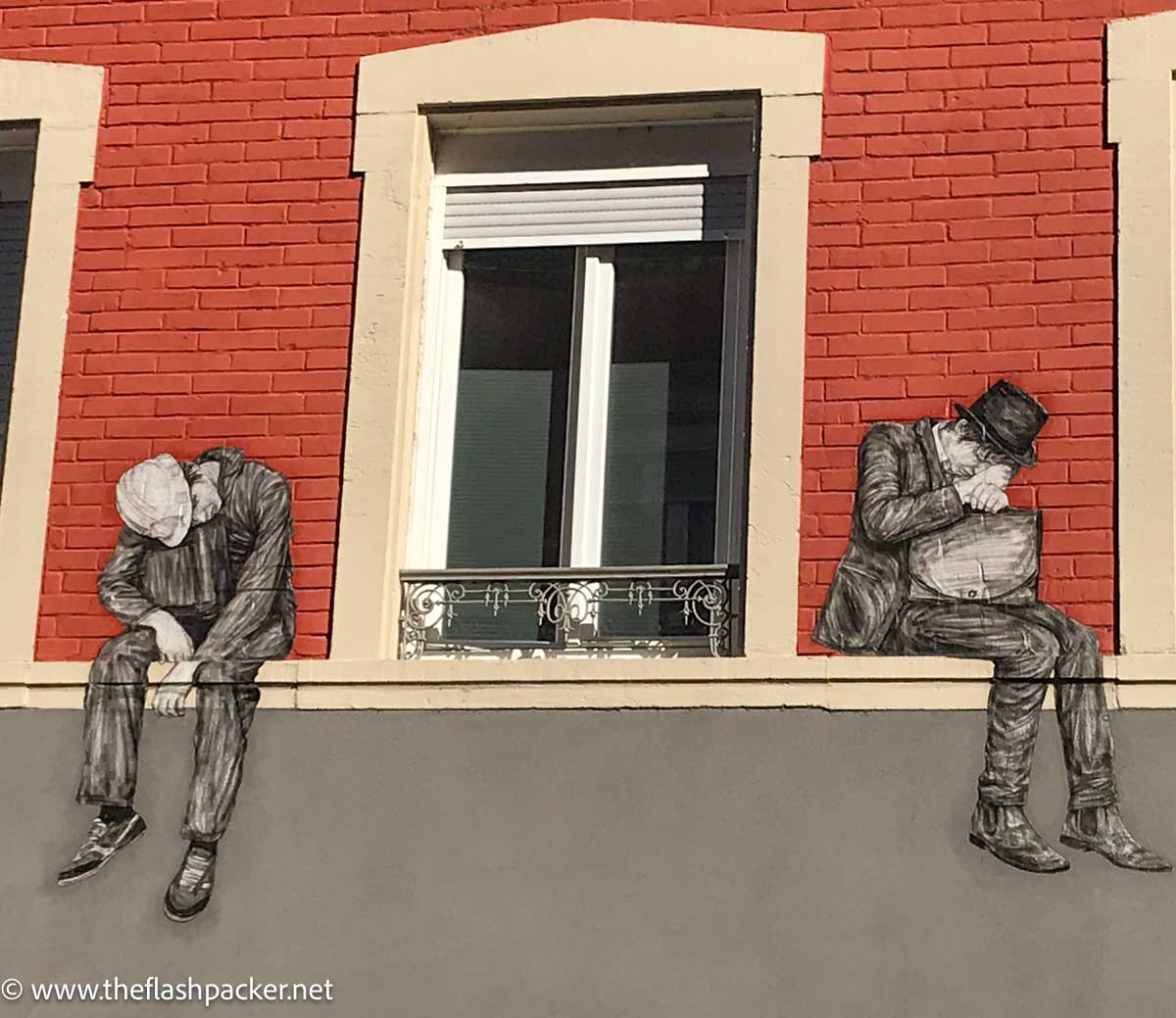 mural of two men on either side of a window