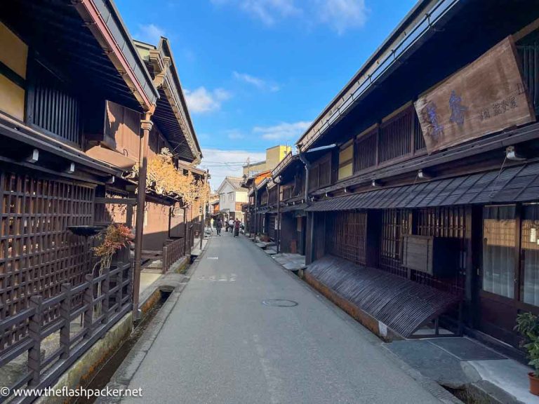 narrow street lined with traditional wooden houses in takayama japan