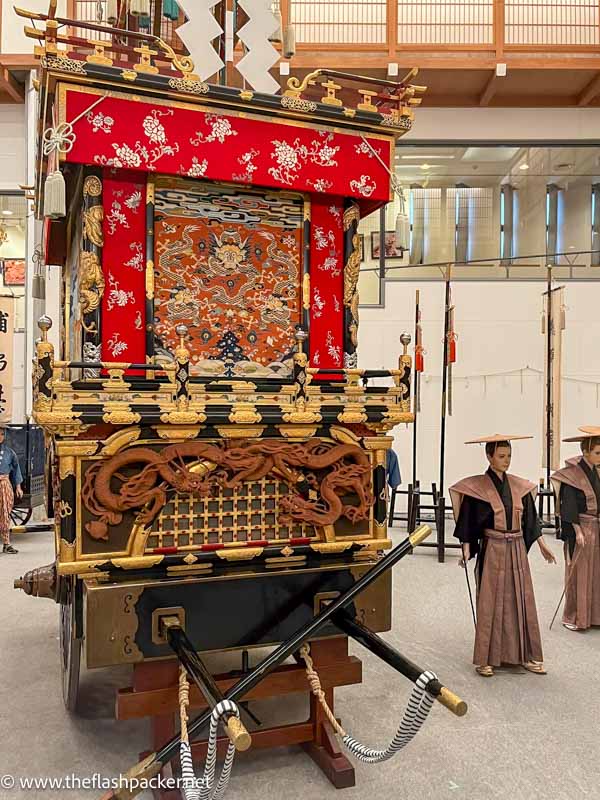 highly decorative japanese festival float and life size models of people