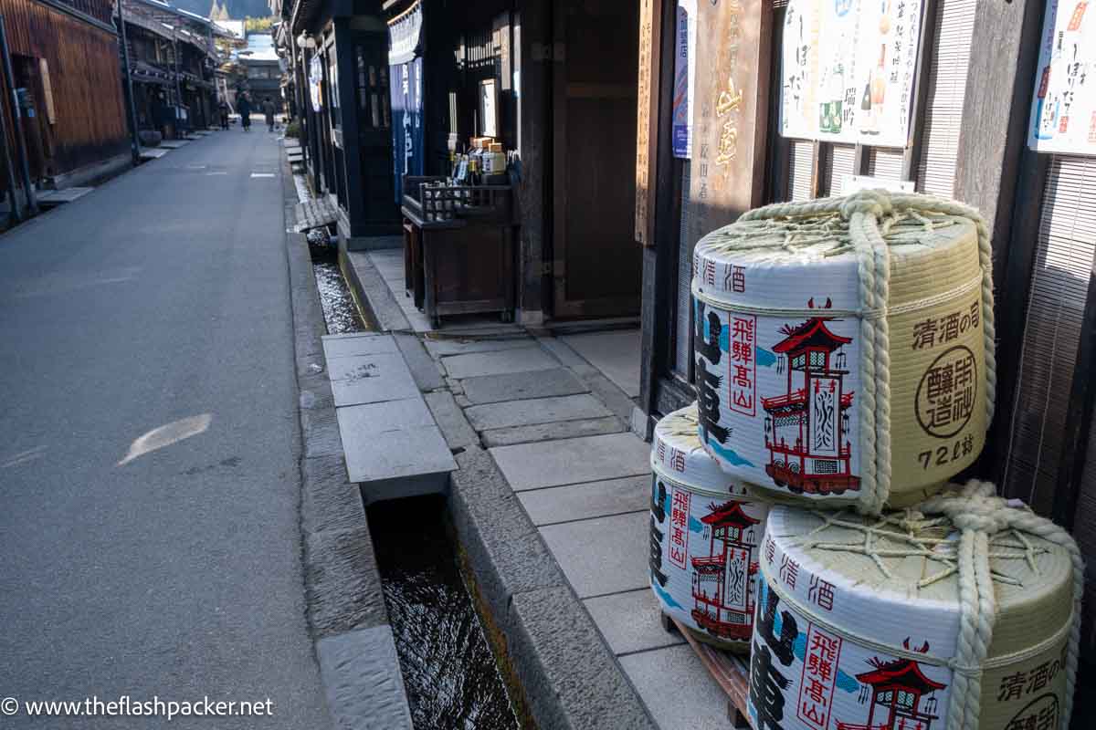 sake barrels in a picturesque street in takayama japan with traditional wooden buildings