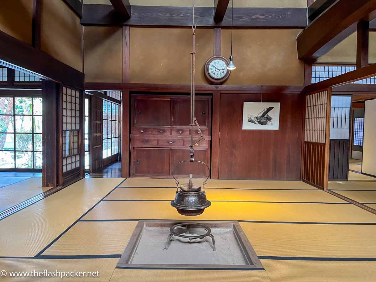 kettle hanging in the center of a room in a traditional japanese house