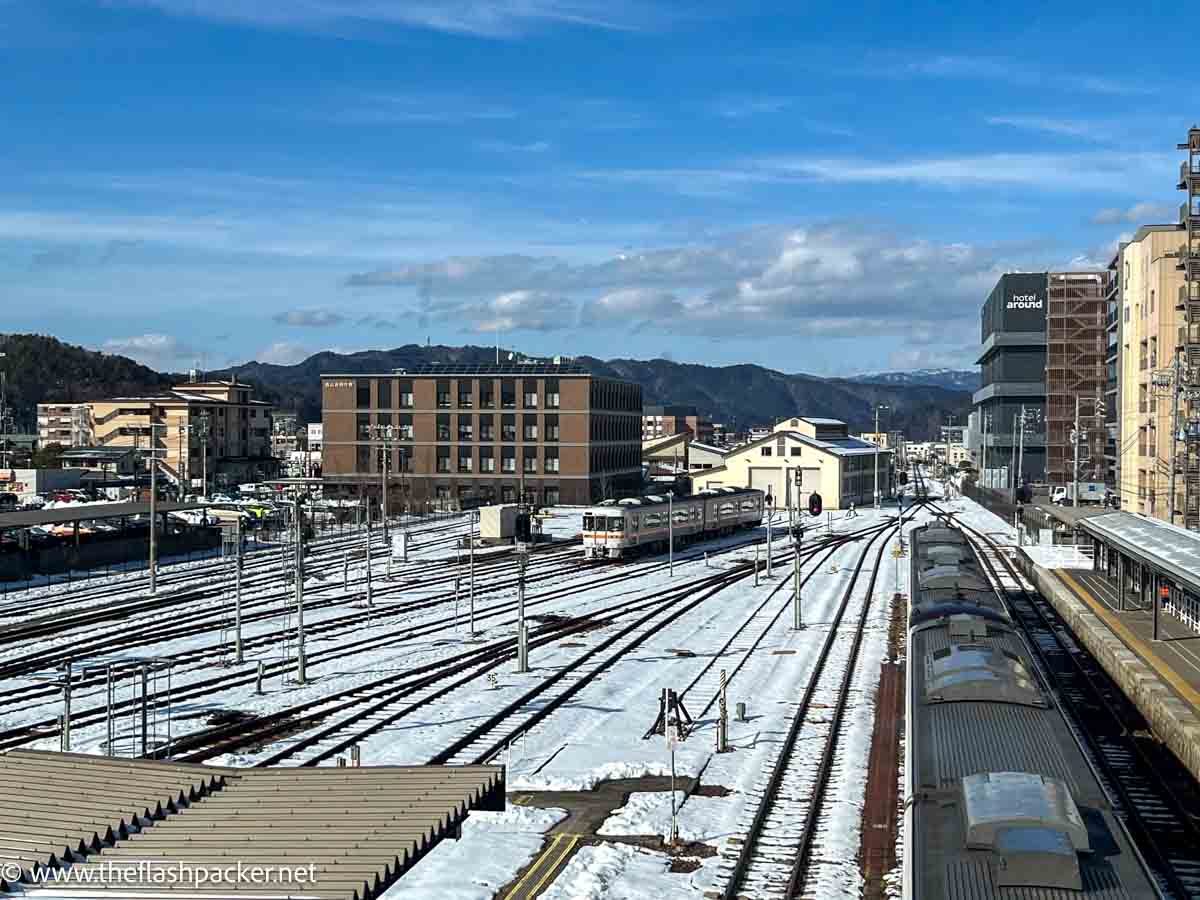 snow covered tracks at takayama railway station in japan