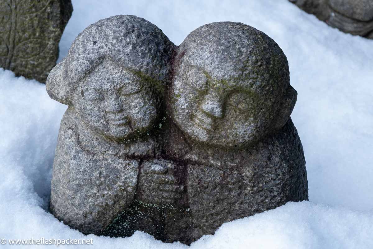 small stone sculpture of an embracing couple