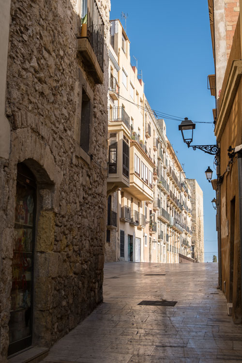 medieval street with sand and ochre coloured buildings