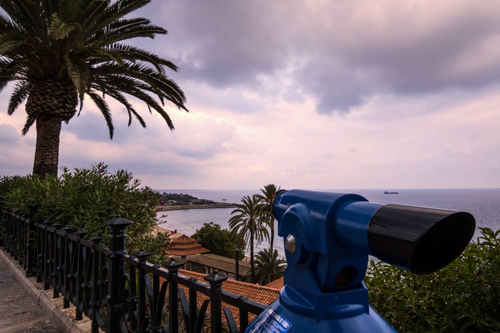 mediterranean viewpoint with telescope at dusk