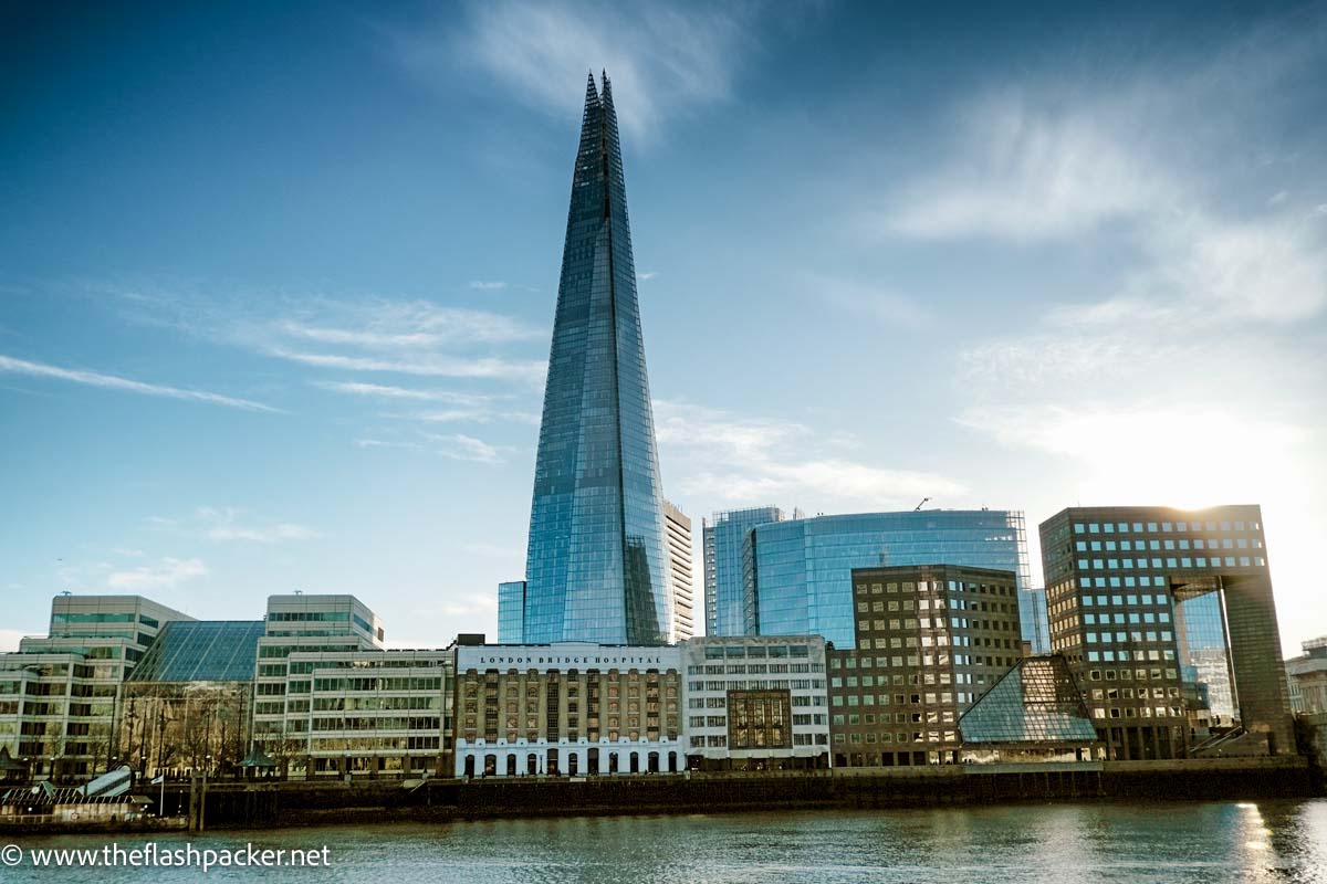 the pointed building of the shard alongside the river thames in london