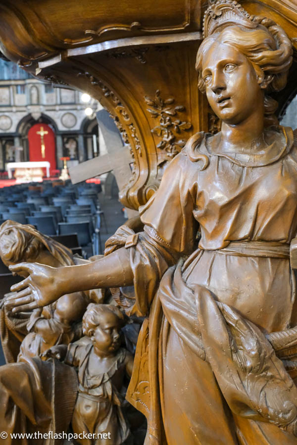 carved figure of a woman on a cathedral pulpit