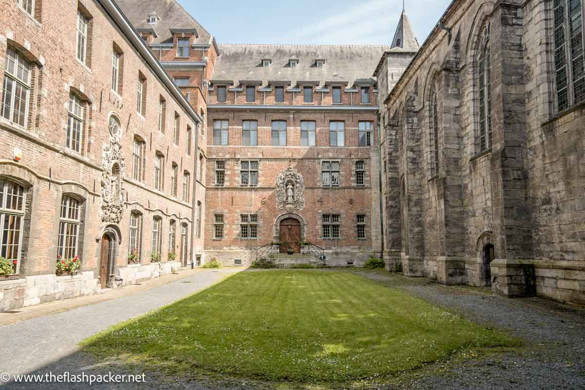 grassed courtyard inside old redbrick seminary building in tournai