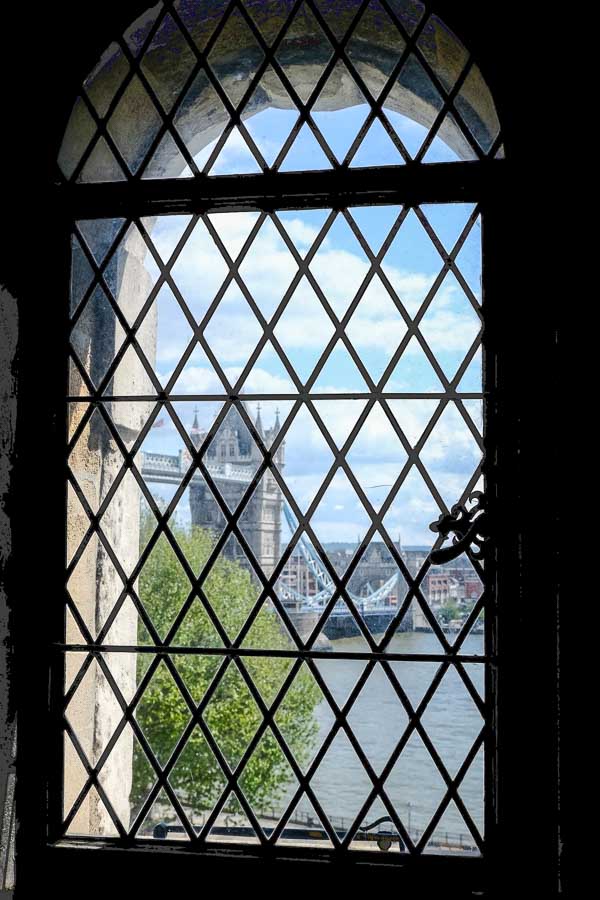 tower bridge seen through a leaded window at the tower of london