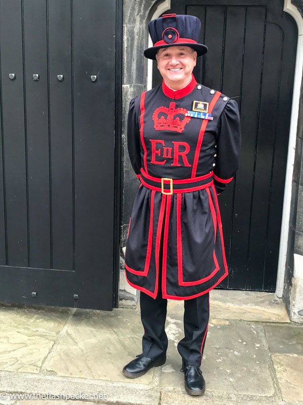 yeoman warder dressed in a black and red uniform