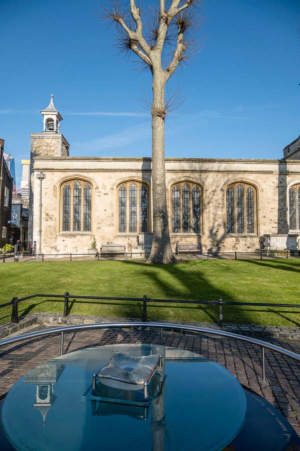 stone church behind large bare tree