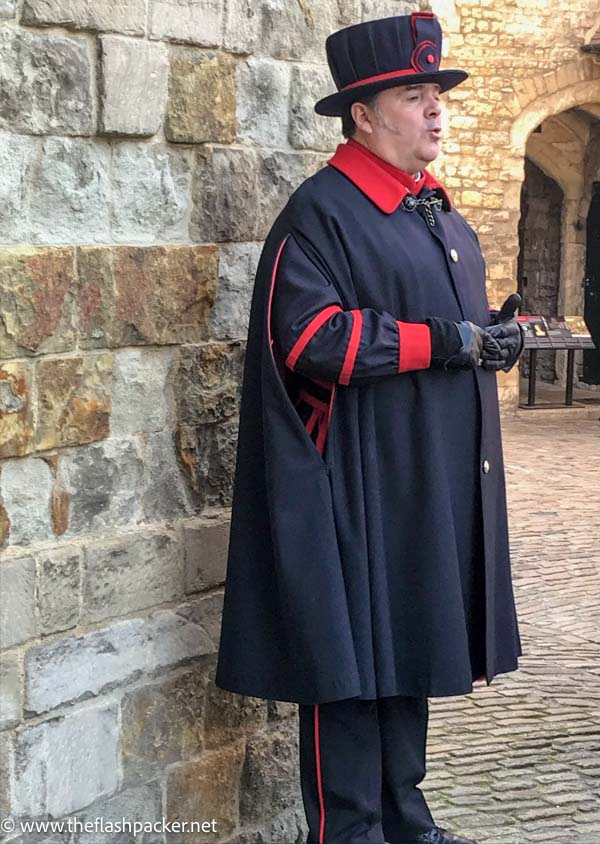 yeoman warder dressed in a black and red uniform