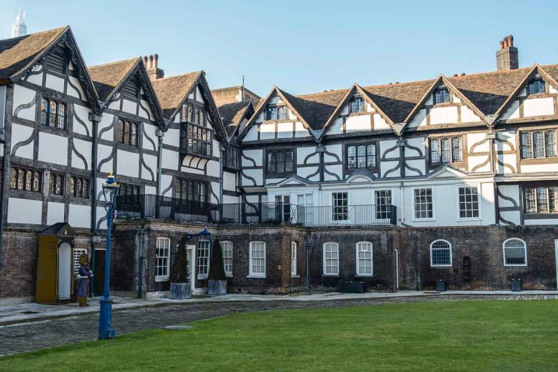 soldier on guard outside tudor buildings