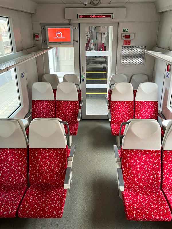 interior of slovak train with rows of red seats