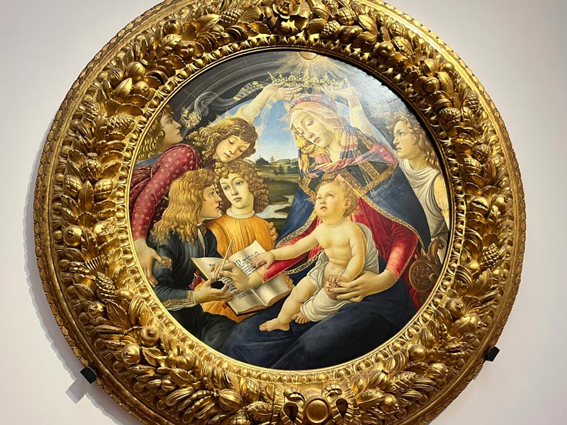 circular painting of madonna and child with angels