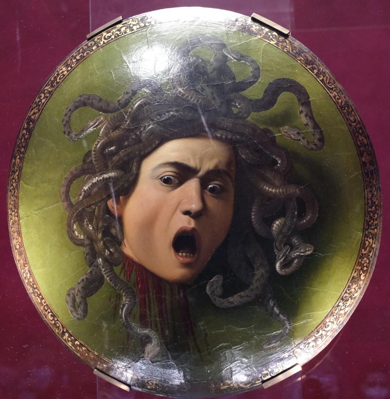 painting of medusa by carravaggio showing man with hair made of serpents