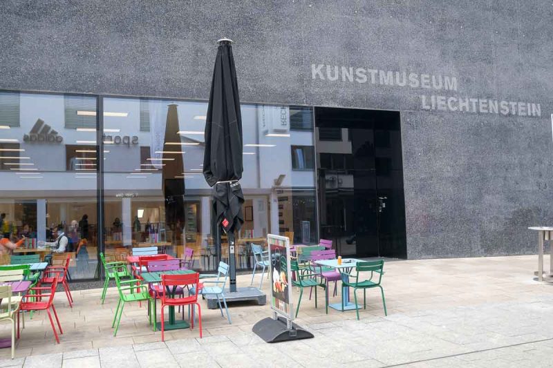 brightly coloured tabes and chairs outside liechtenstein kunstmuseum