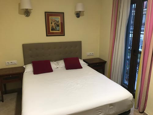 simple hotel room with double bed and bedside tables