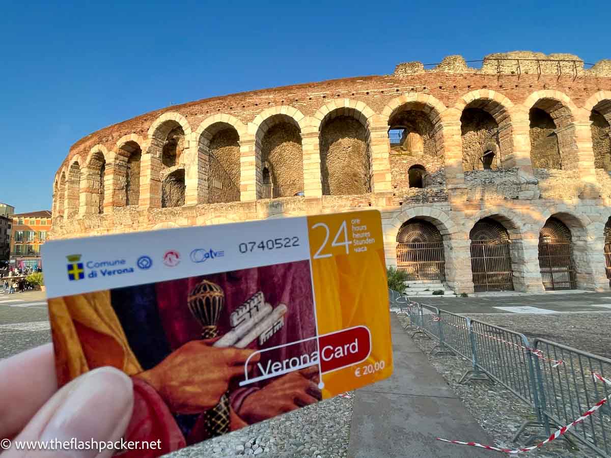 person holding a verona card in front of roman arena