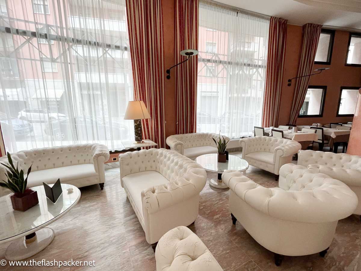 lobby in hotel giberti in verona with beige leather chairs and sofas