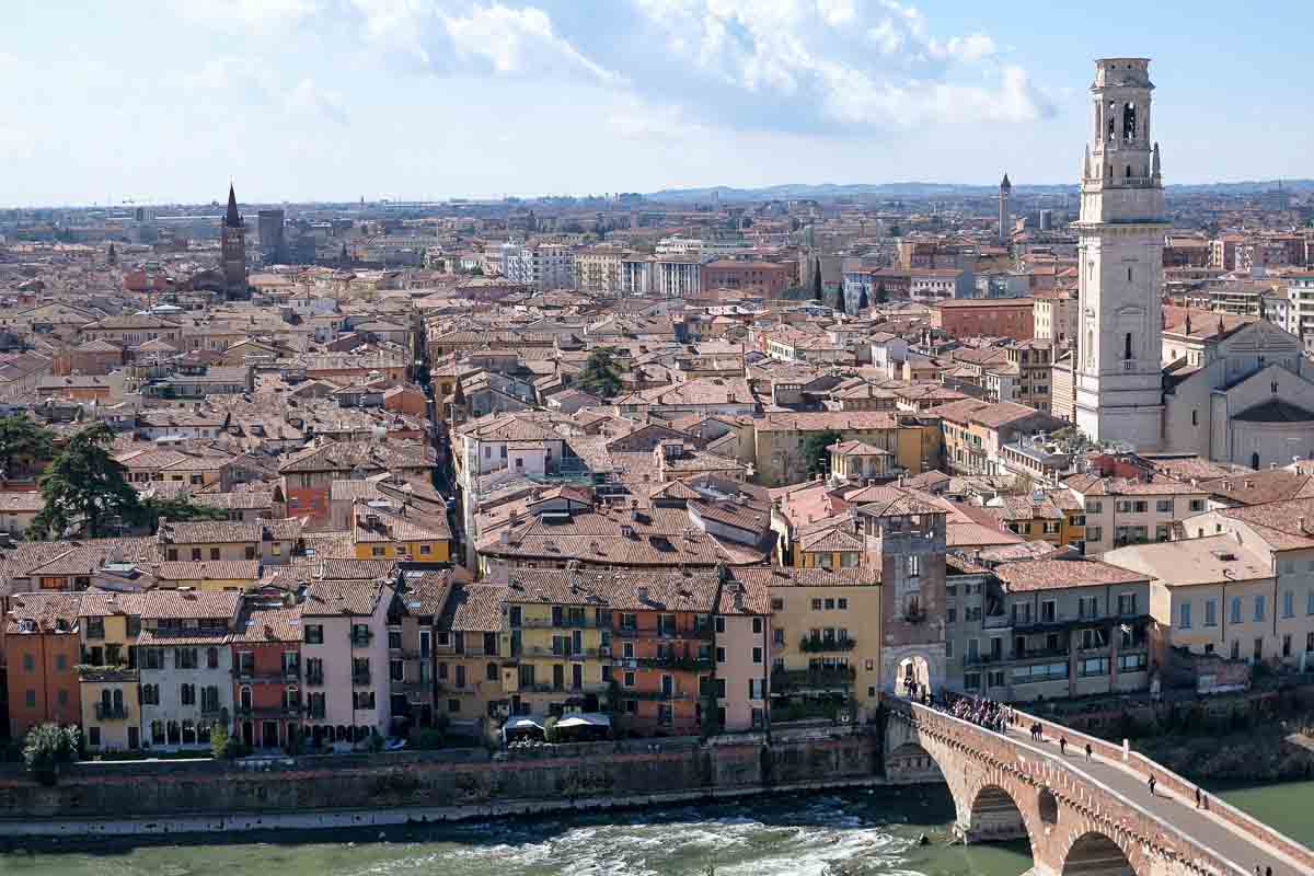 red rooftops of verona italy with stone bridge and tall bell tower