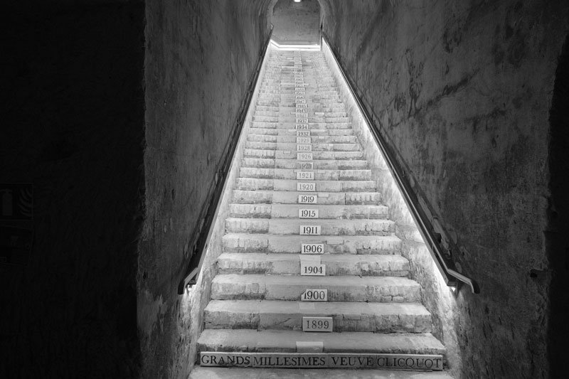 set of steps to veuve clicquot champagne cellars marked with different years