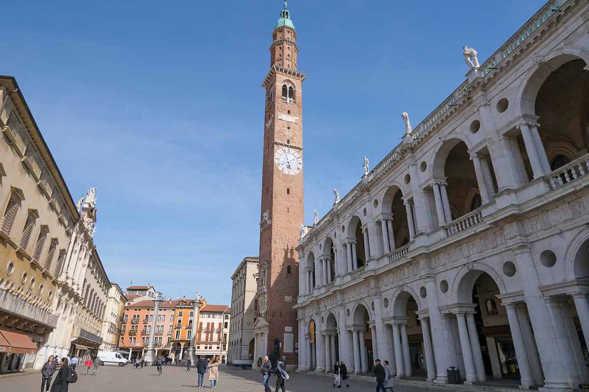 red brick bell tower and arcaded buildings in piazza dei signori in vicenza italy