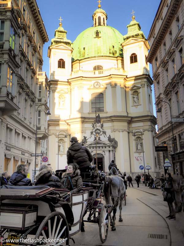 people in a horse drawn carriage in the streets of vienna austria