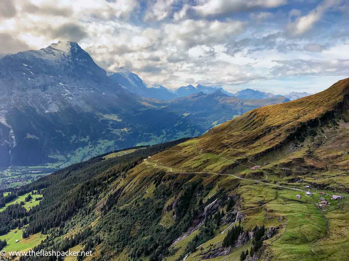 a spectacular alpine valley with snow topped mountain peaks