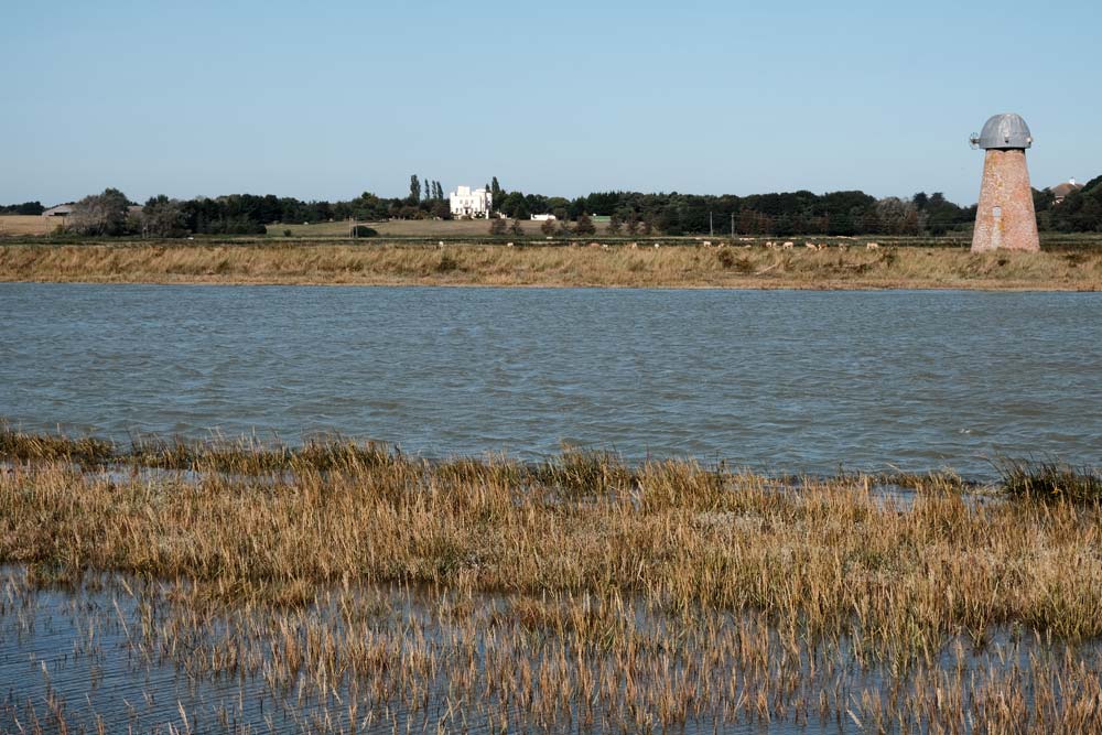 river and reed beds and disused windmill in walberswick suffolk