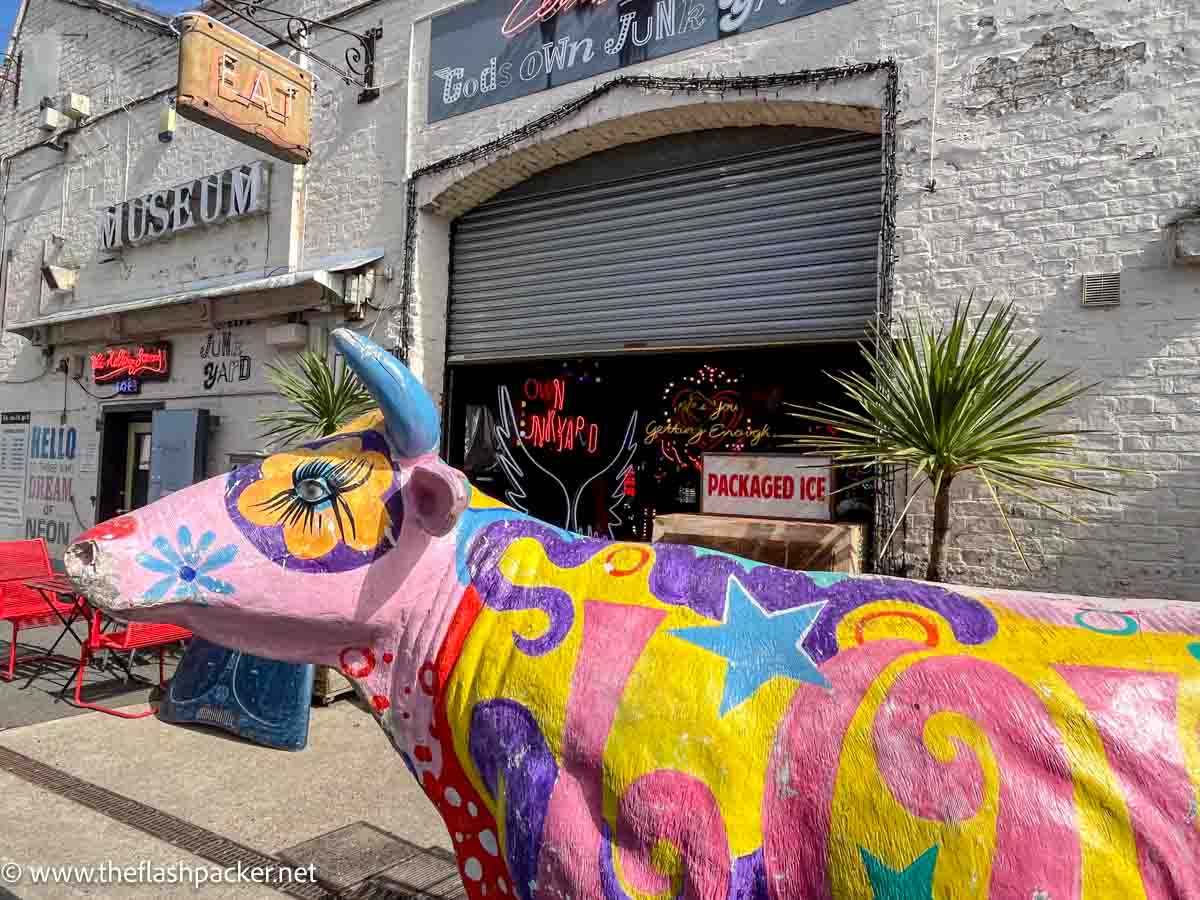 painted wooden cow outside the front of gods own junkyard in Walthamstow london