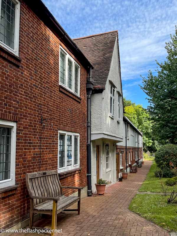 bench in front of row of almshouses