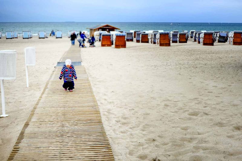 small child on boardwalk leading to sea