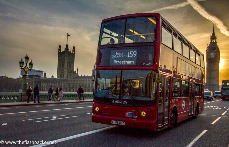 double decker bus on bridge at sunset