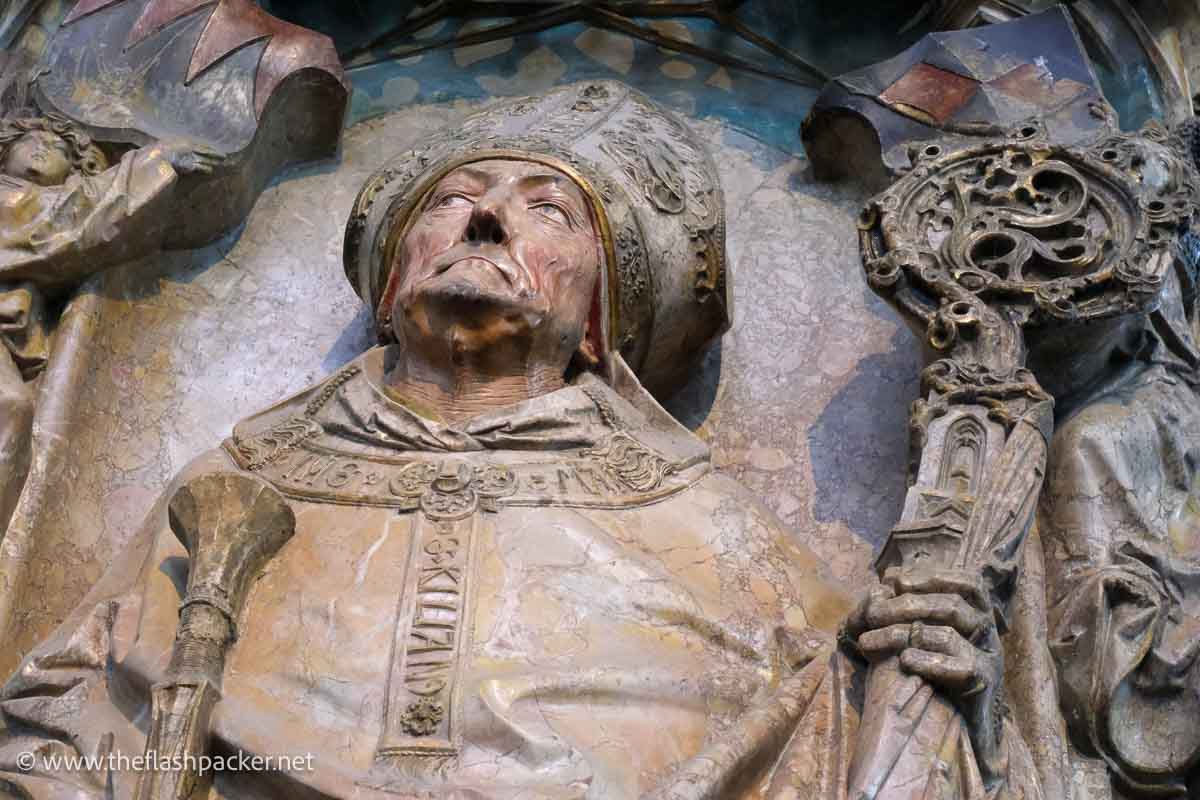 stone effigy of a bishop holding a mitre