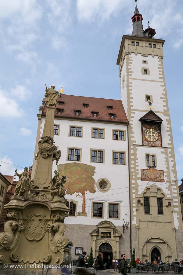 town hall building in wurzburg with clock tower and frescoes on facade