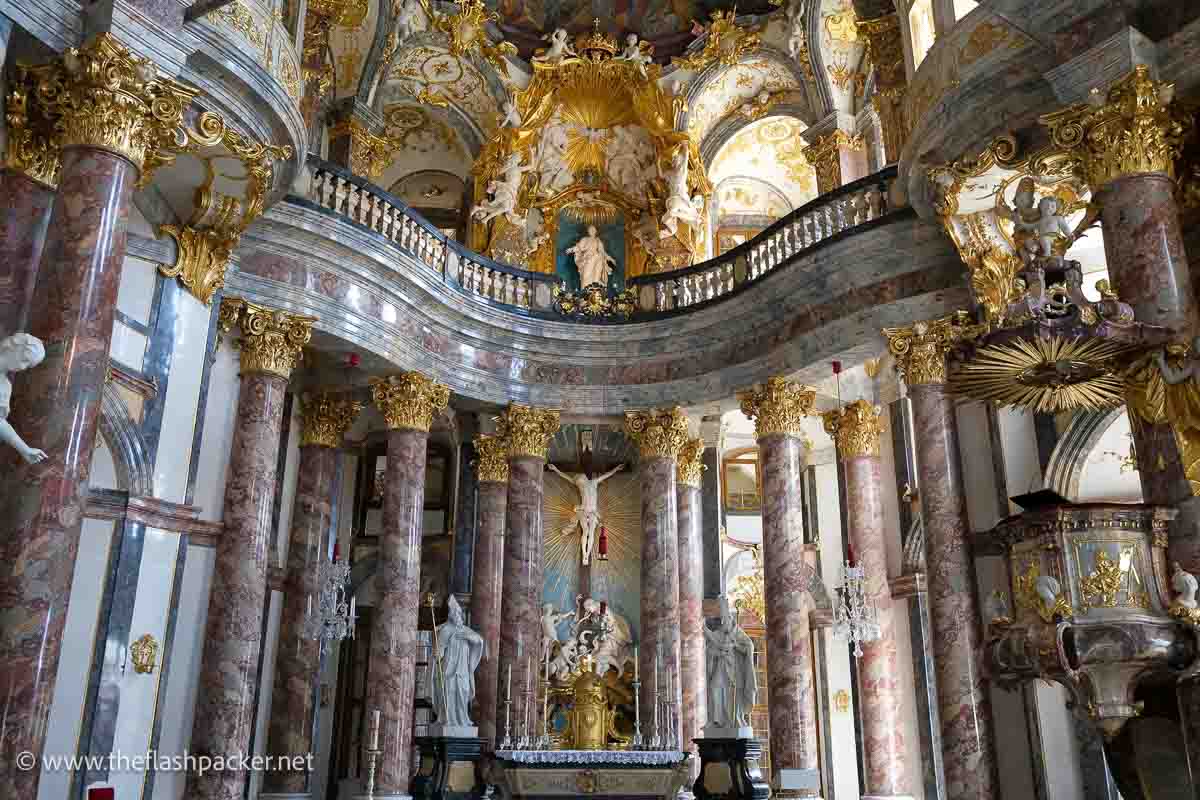 altar of main chapel of wurzburg residence with polychrome marble columns and gilded ceiling