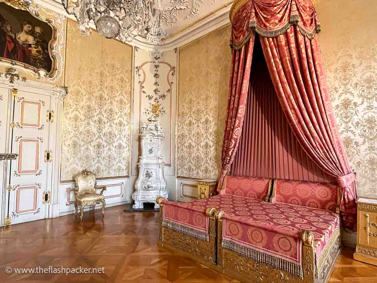 bedroom in wurzburg residence with large bed covered in red drapery