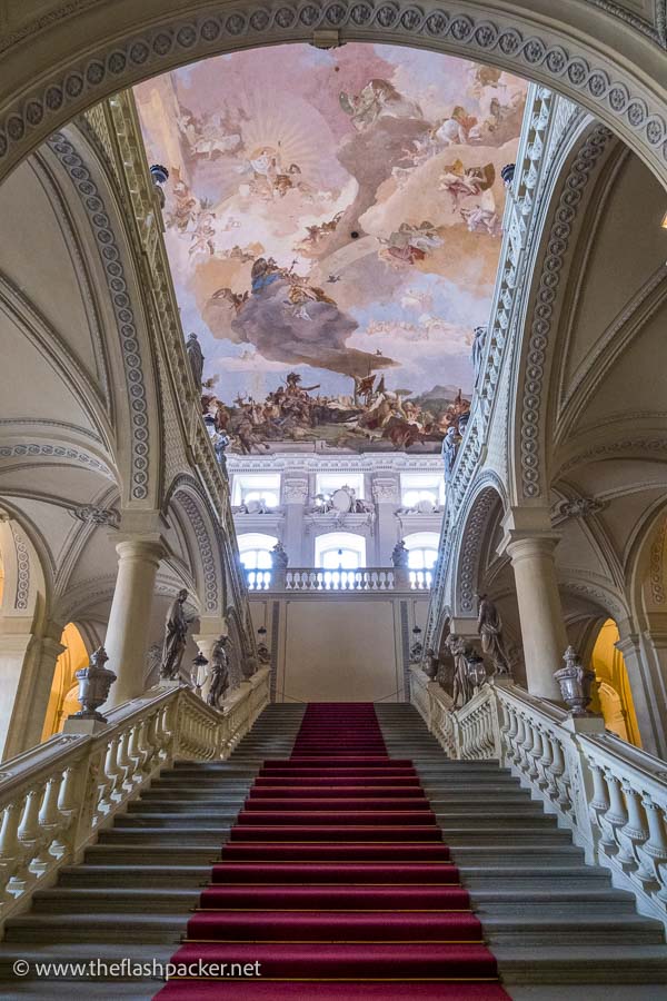 monumental staircase below a frescoed ceiling in wurzburg residence