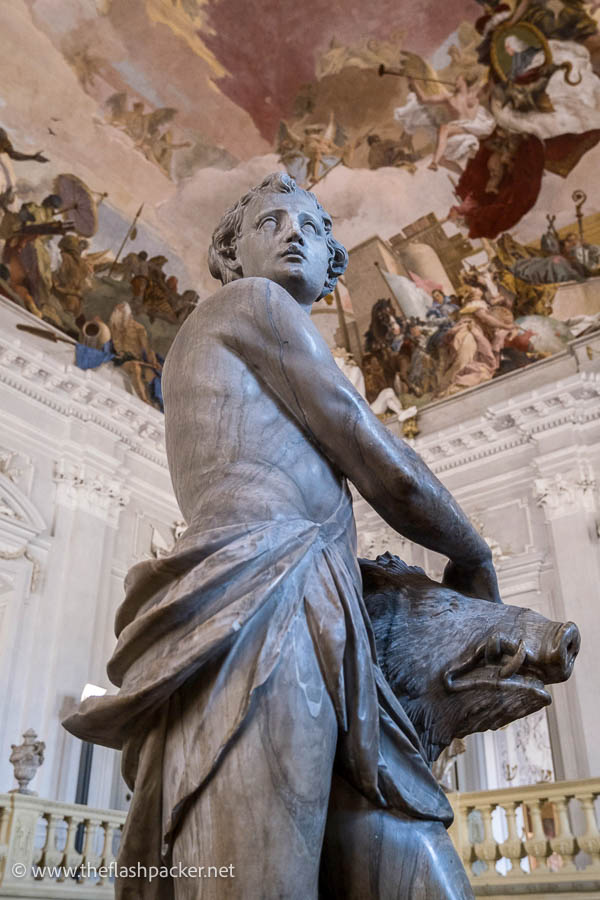 marble sculpture of a boy with an animal